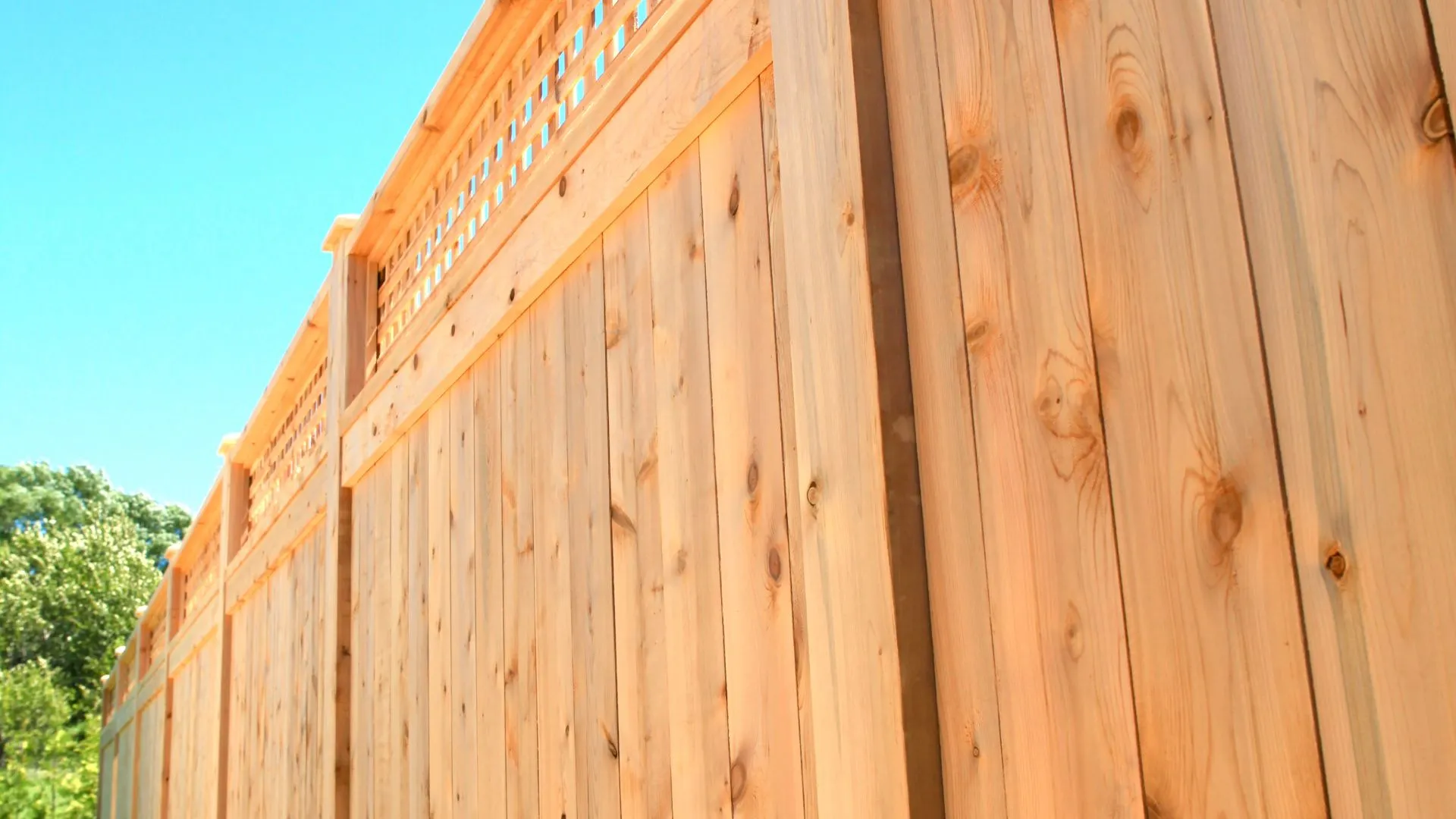 cedar privacy fence with clear blue sky background